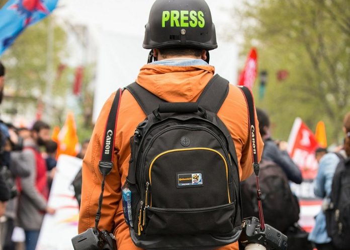 press,reporter A reporter at a protest.